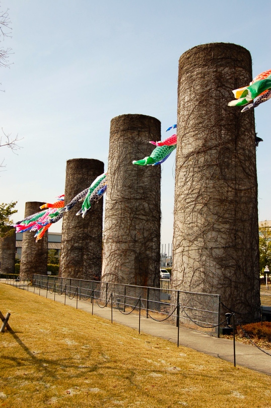 Old chimneys decorated with colourful carp streamers to mark the celebration of Kodomo No Hi (children's day) in May